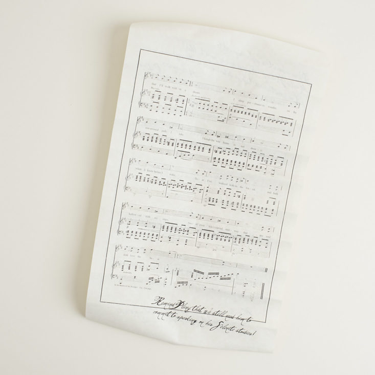 back of unrolled scroll featuring sheet music