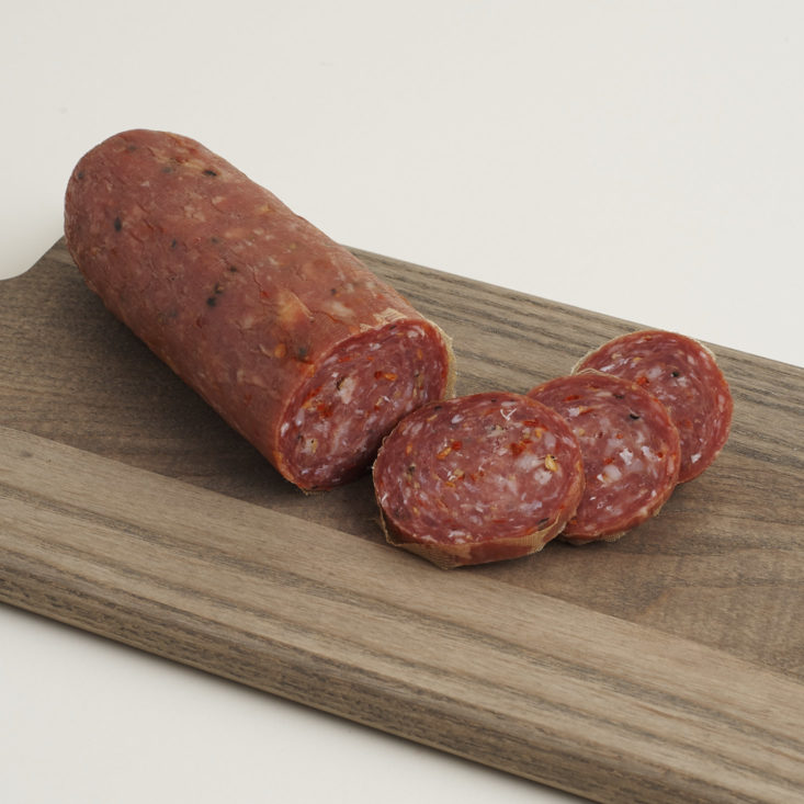 Picante Veneto Style Sopressa from Parma Sausage sliced on a cutting board