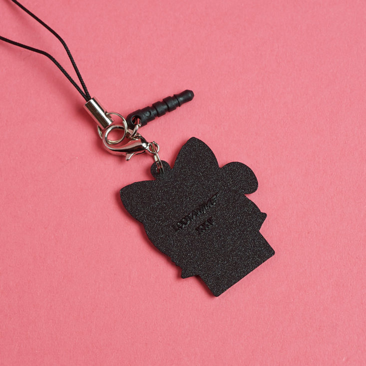 The black back of a purple loot anime mascot phone charm