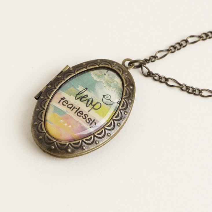 close up of locket that says "leap fearlessly"
