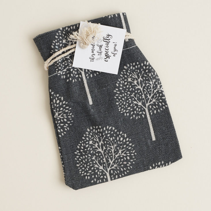 grey cloth jewelry bag with white trees