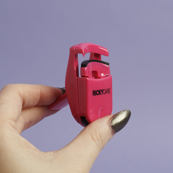 pink ricky care travel lash curler in hand