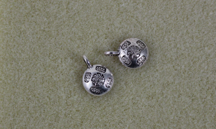 silvery shield shaped charms