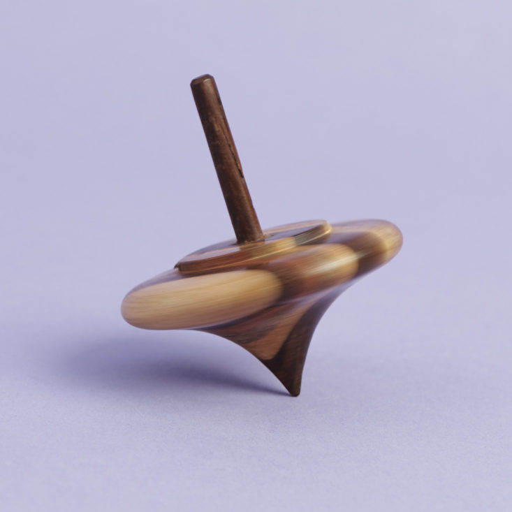 wooden spinning top, in motion