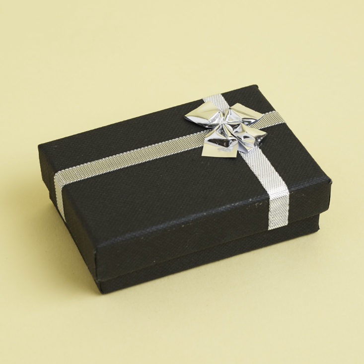 black jewelry box with silver ribbon