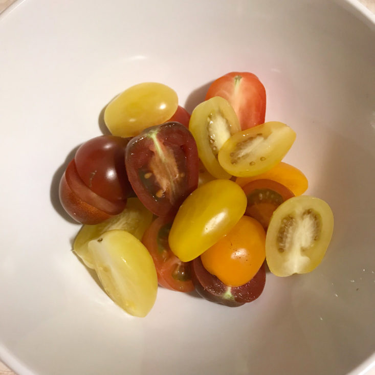halved hierloom cherry tomatoes in bowl
