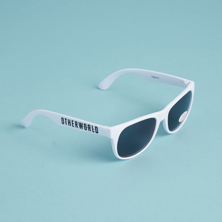 white plastic sunglasses on blue background