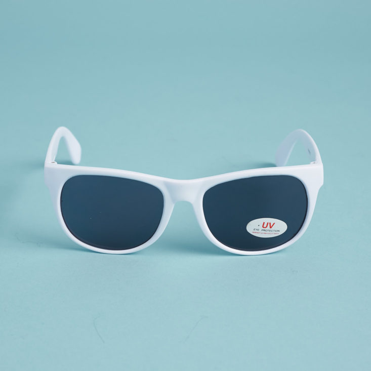 white plastic sunglasses on blue background