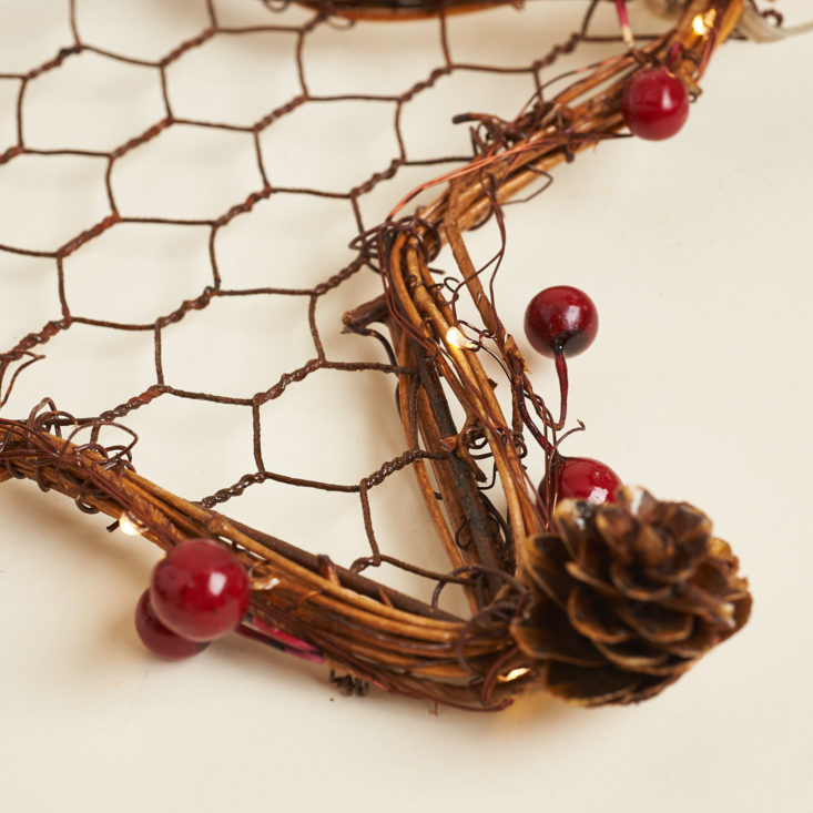 cranberries and pinecones on wreath
