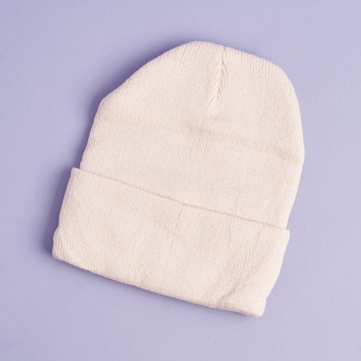 the back of a pale pink beanie hat