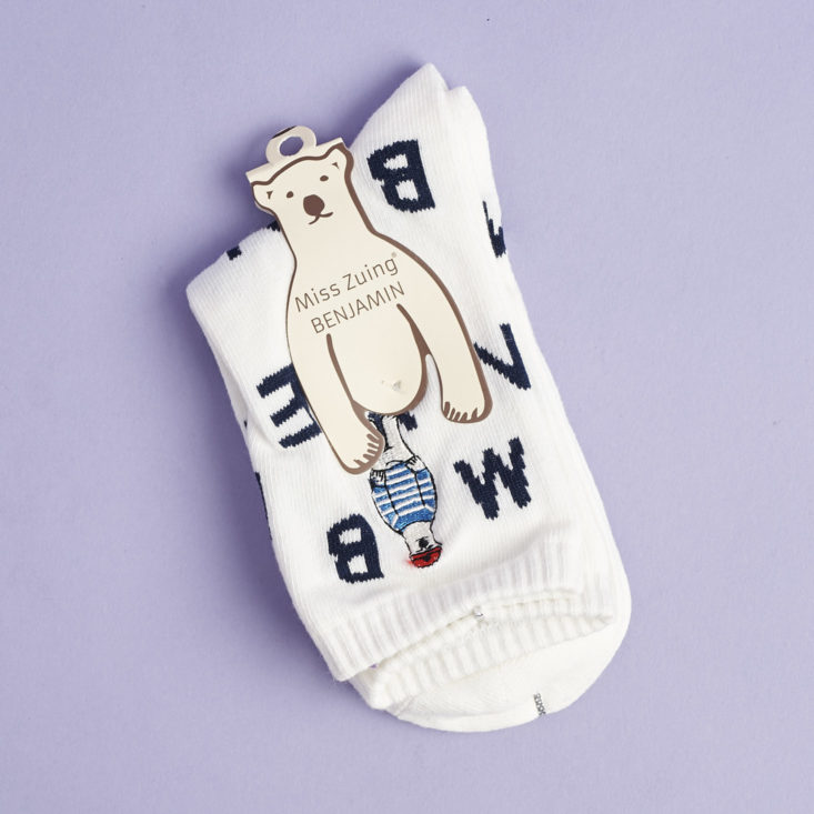 white socks with black letters in their packaging