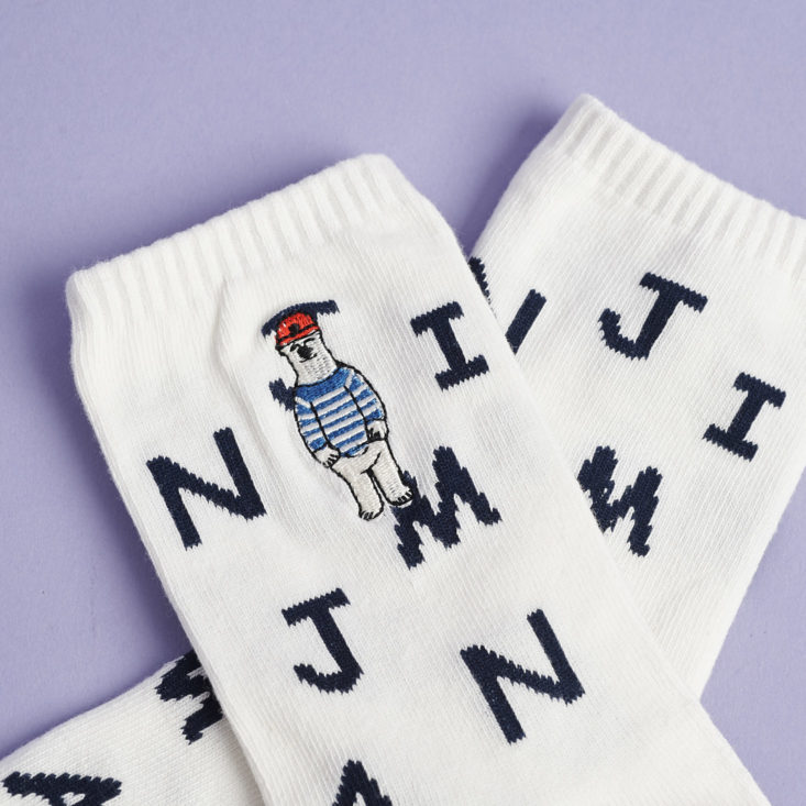 white crew socks with random black letters and embroidered steve zissou-like polar bears embroidered on the ankles
