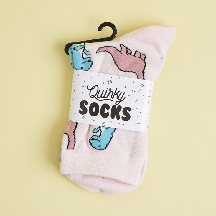 Pink dinosaur socks in package
