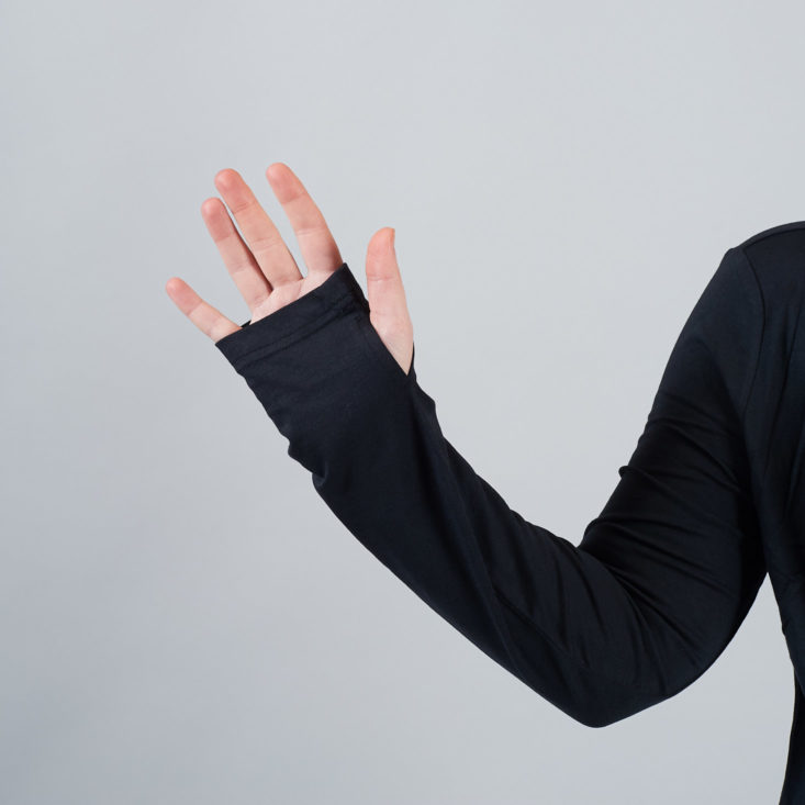 thumbholes modeled by a woman's hand