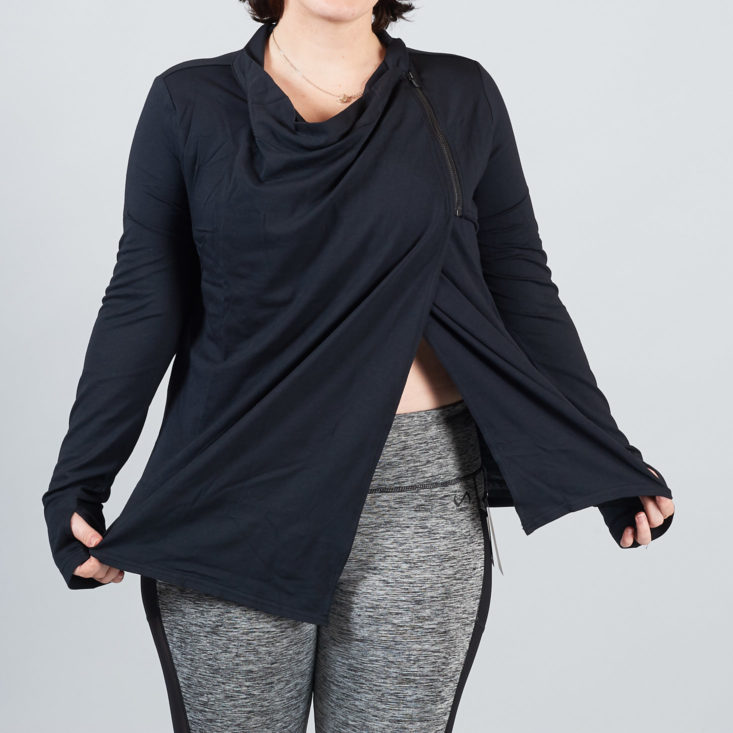 split detail of a black wrap-style jacket on a woman