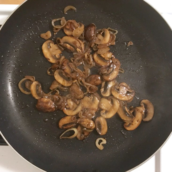 mushrooms and shallots cooking in pan with soy glaze