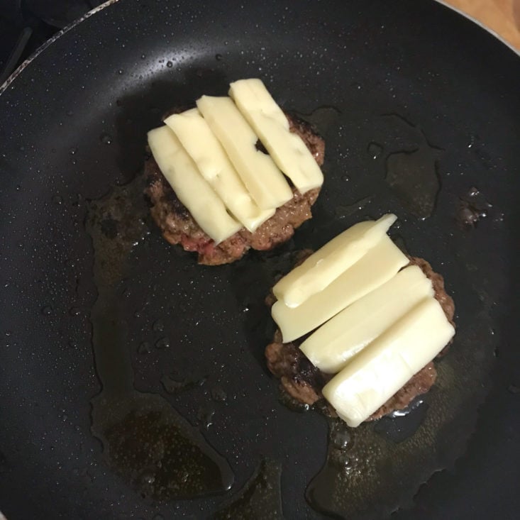 other side of burgers with cheese cooking in pan