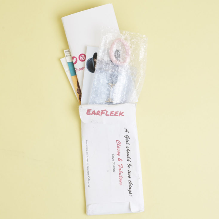Earfleek minimalist envelope with items coming out