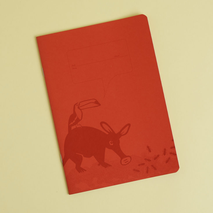 red notebook with anteater and toucan on front