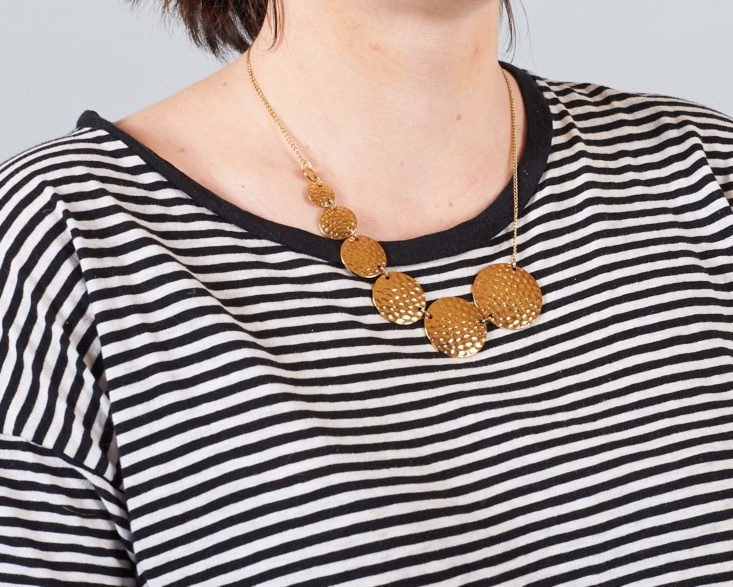 coin necklace on model