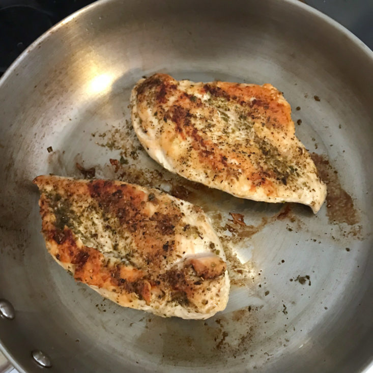 chicken breasts cooking in pan