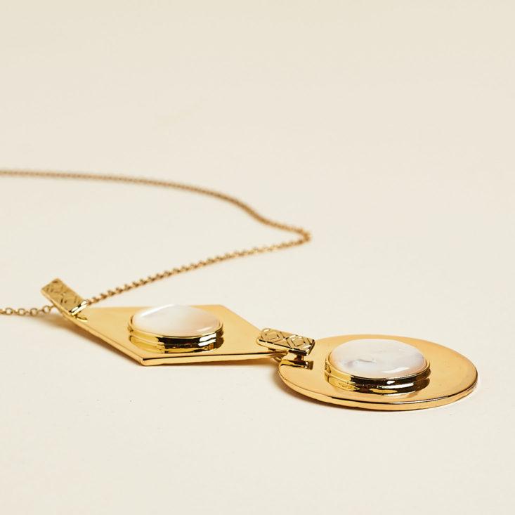 gold pendant necklace laid flat