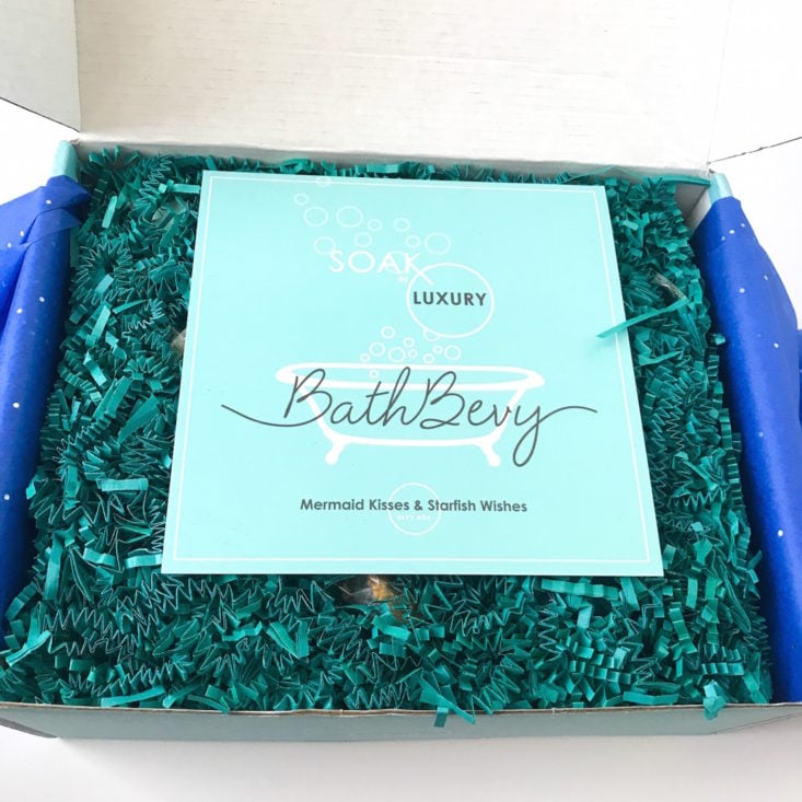 open Bath Bevy showing green crinkle paper and info card