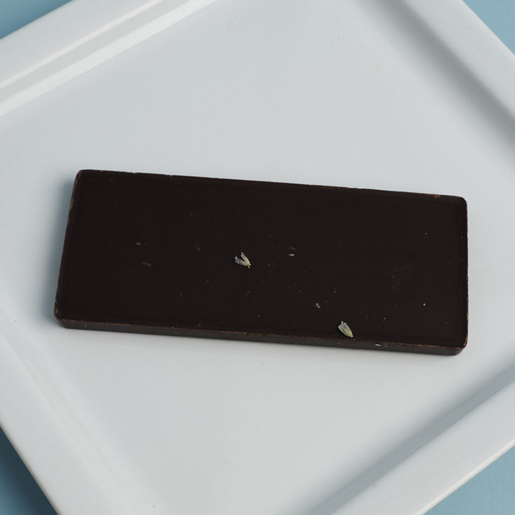 front of Elements Truffles Ginger and Black pepper Artisanal Chocolate Bar on plate