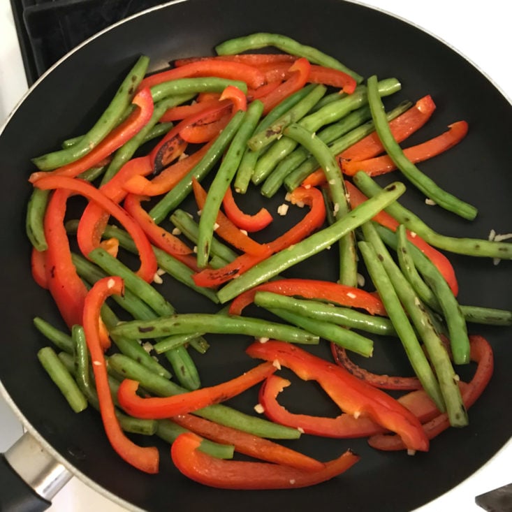 red peppers, green beans, and garlic in skillet