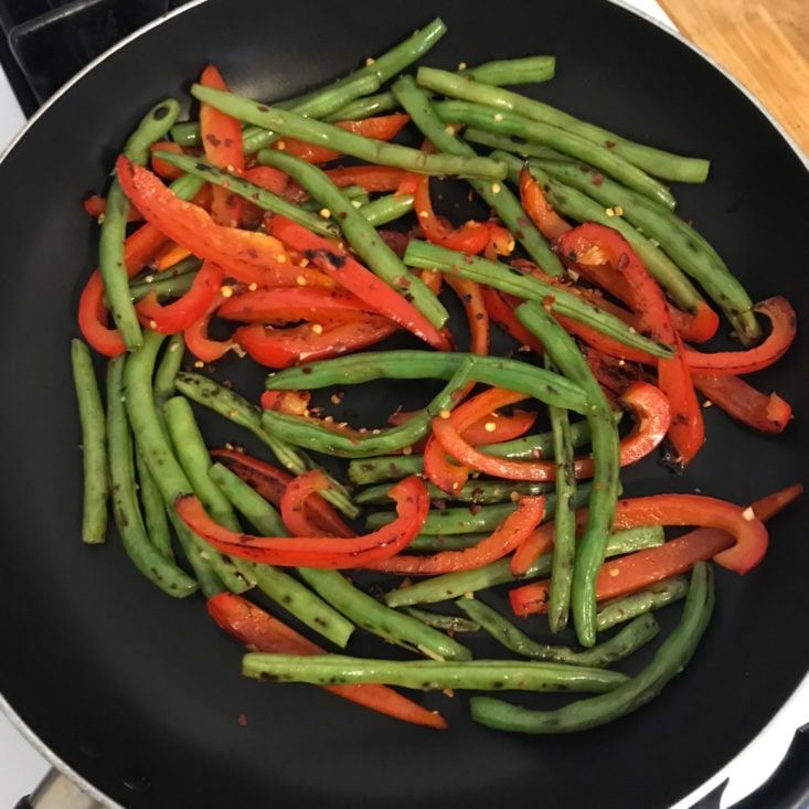 red peppers, green beans, garlic, and red pepper flakes in skillet