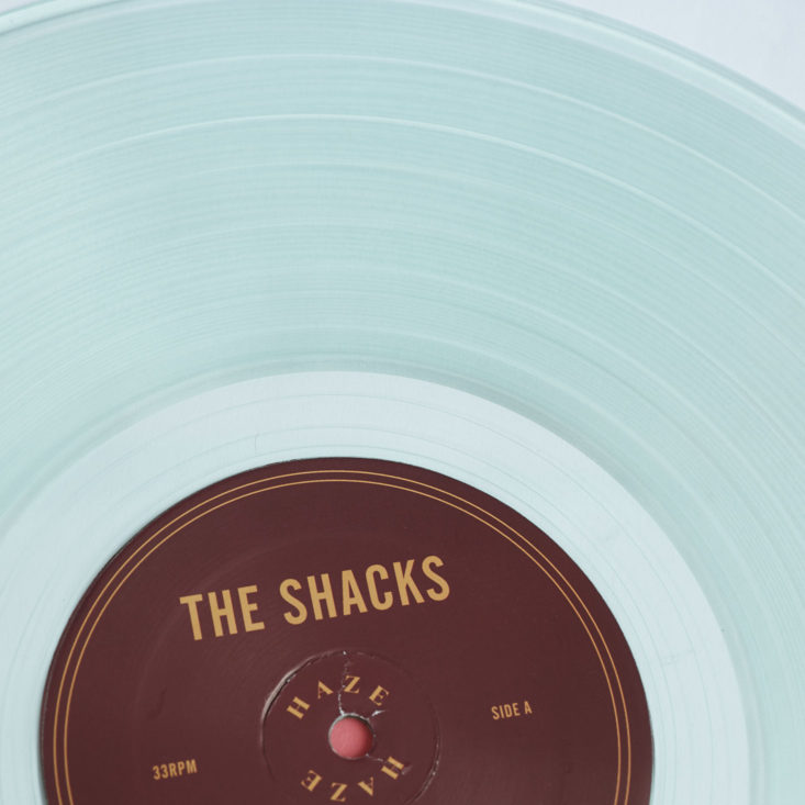 close up of The Shacks Haze LP on coke bottle clear vinyl