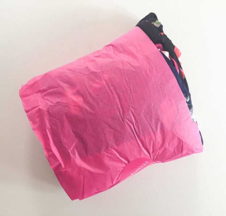 nadine west clothing wrapped in pink tissue paper