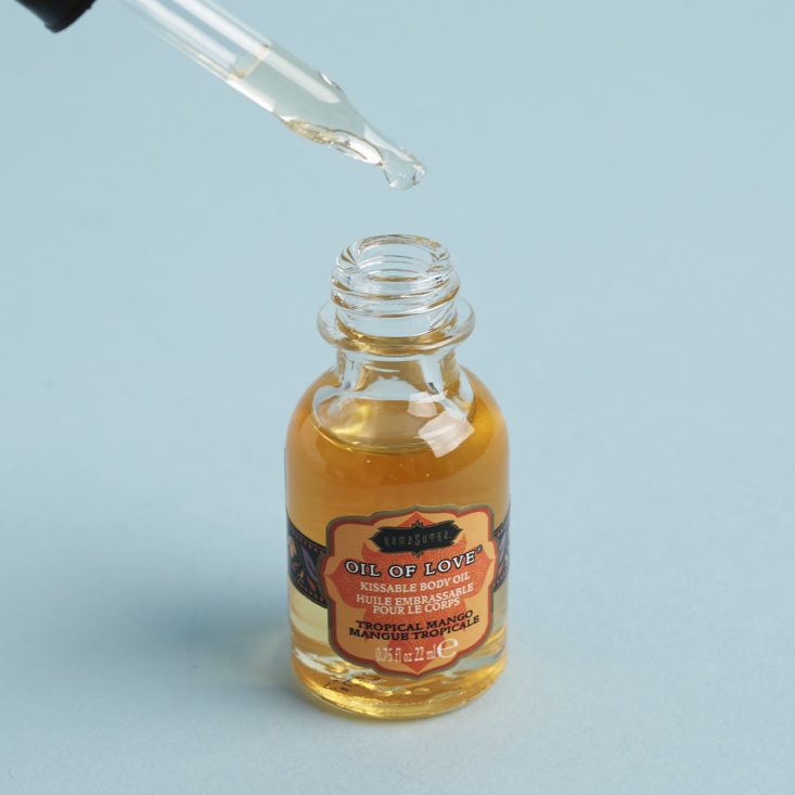 Kama Sutra Tropical Mango Oil of Love with dropper in use