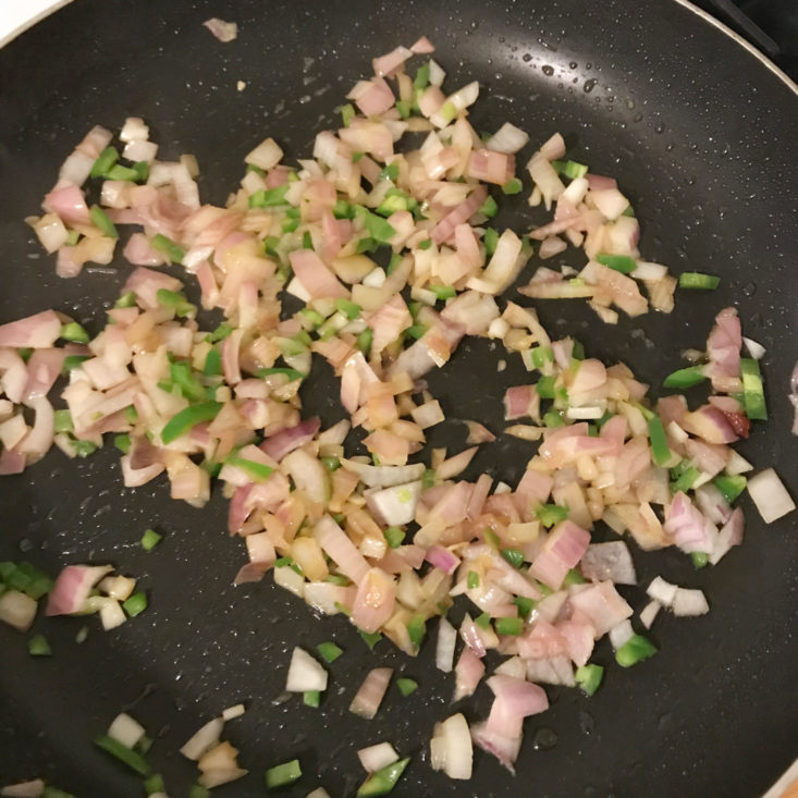 onion and jalapeno cooking in pan