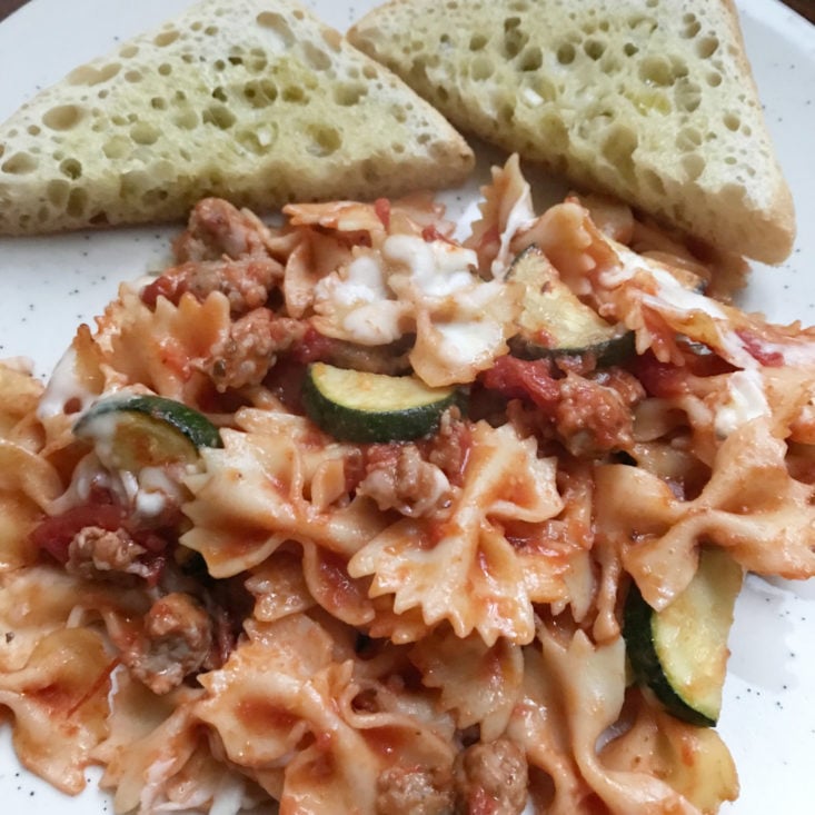 close up of Baked Italian Sausage Farfalle with garlic bread