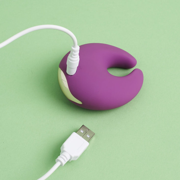 Romant Moon Vibrator with charging cord plugged in