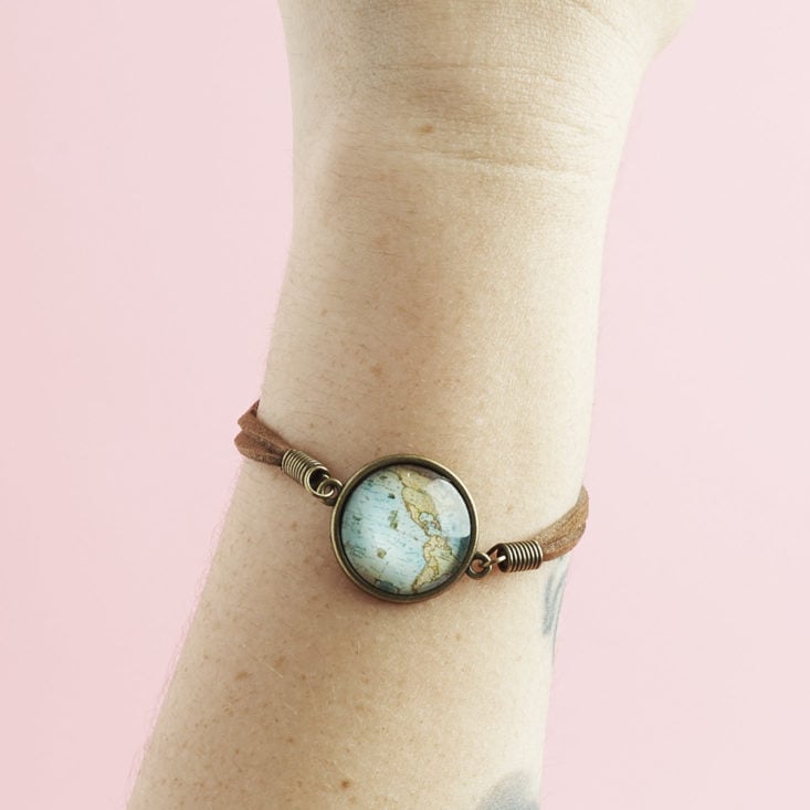 faux leather and brass map bracelet on arm
