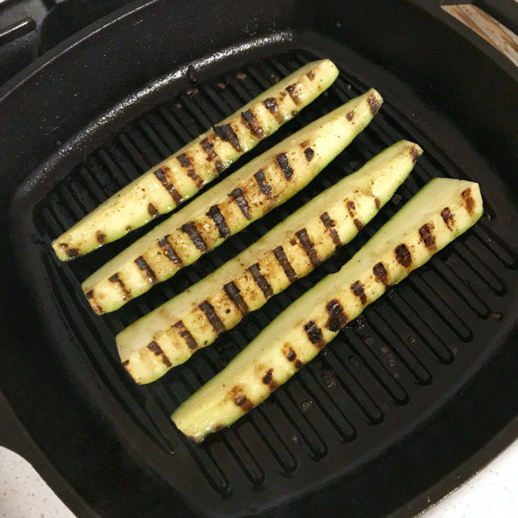 sliced zucchini cooking in grill pan