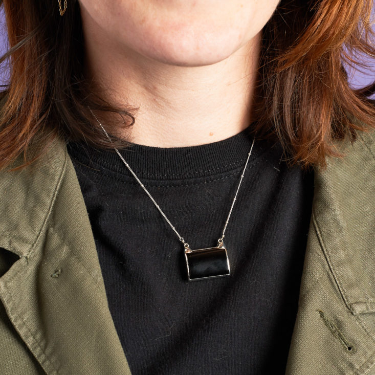happy rebel box necklace on model