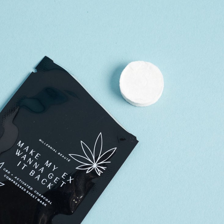 Millennial Beaute CBD + Charcoal Sheet Mask coming out of package