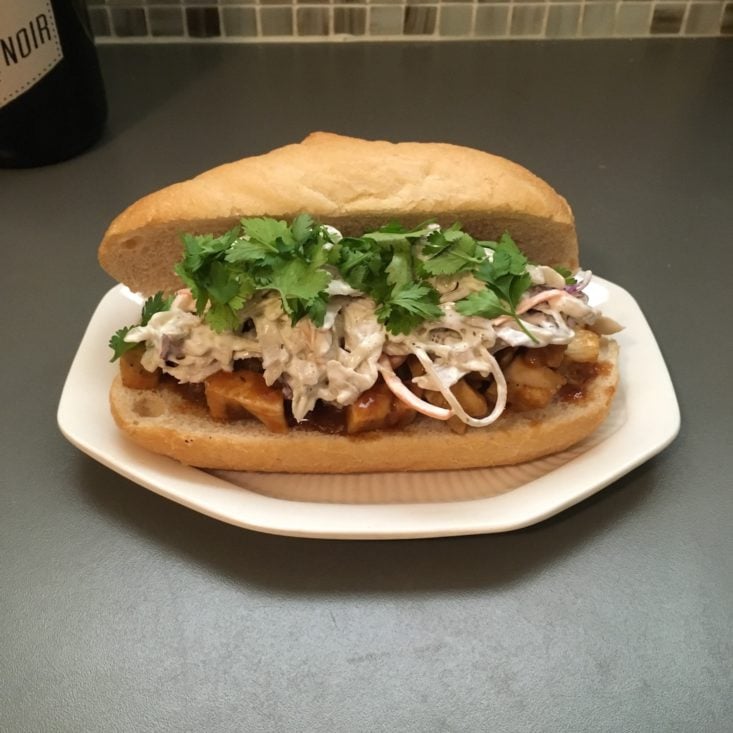 completed korean BBQ chicken sandwich on a small white plate