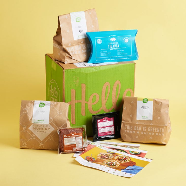Hello Fresh subscription with three meals and recipes displayed around the box.